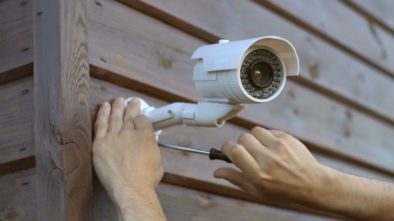 Technician installing a wireless CCTV camera